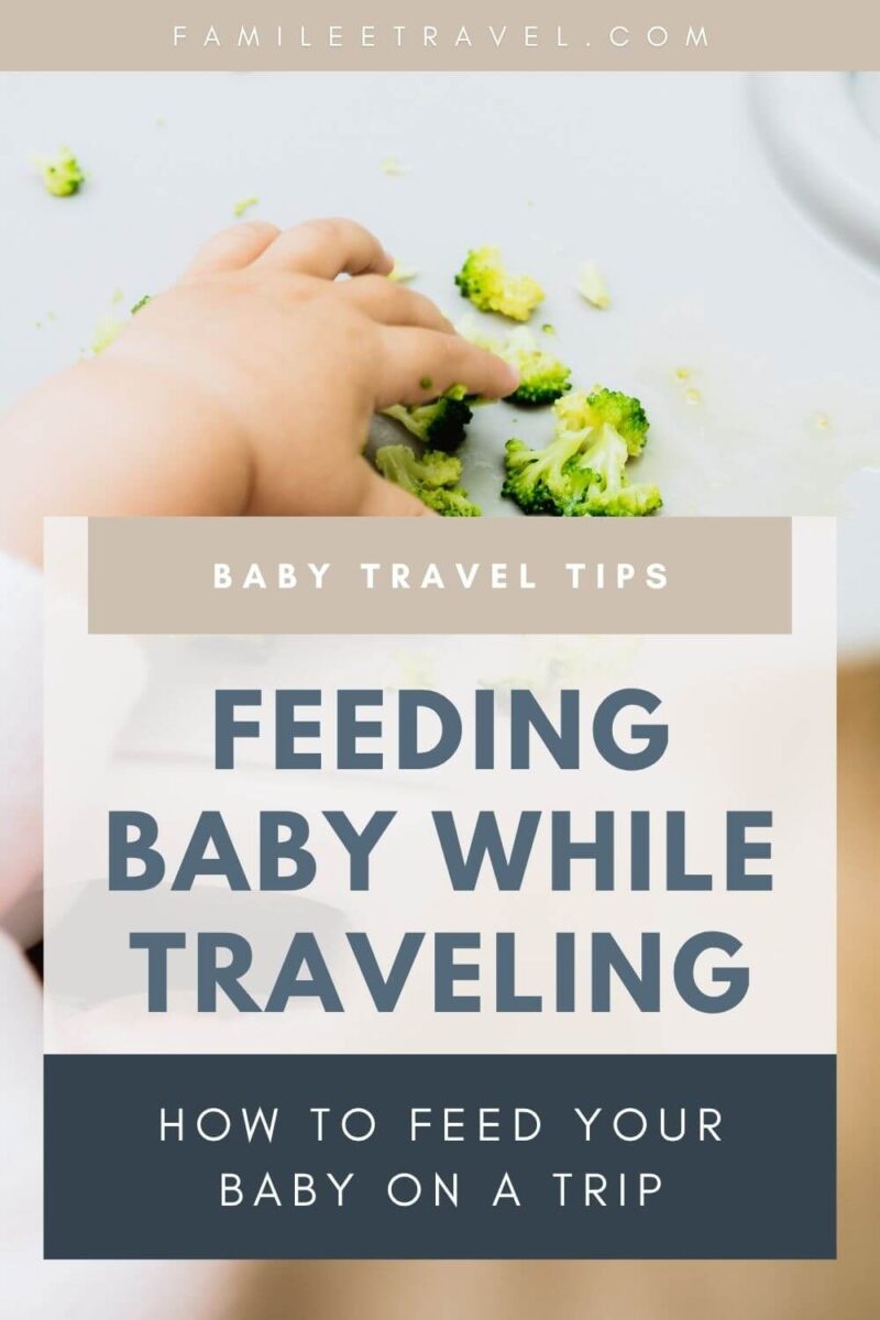 Baby’s hand picking up small broccoli florets on a tray during mealtime, illustrating baby feeding while traveling and introducing finger foods on the go. Designed as a Pinterest graphic style image with text covering a lot of the image image and reads “[FAMILEETRAVEL.COM](http://famileetravel.com/)”, “BABY TRAVEL TIPS”, “FEEDING BABY WHILE TRAVELING”, and “HOW TO FEED YOUR BABY ON A TRIP”.
