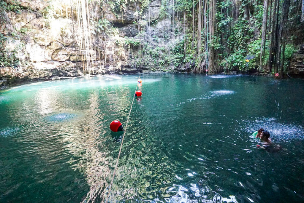 Dad and toddler swimming in the cenote 