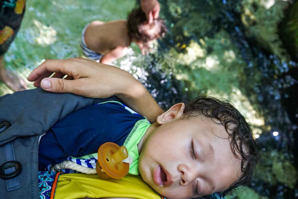 Baby sleeping through his cenote visit (mom is standing in the pool)