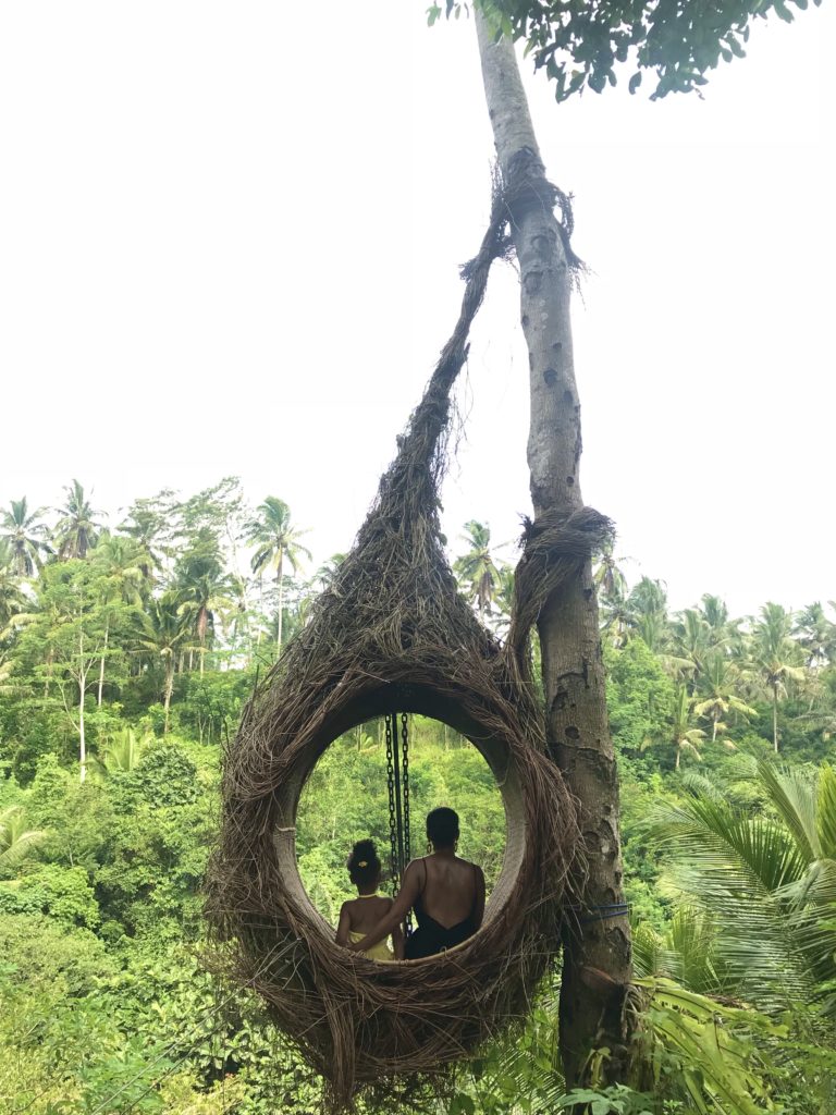 Black mom and daughter sitting in Bali nest egg