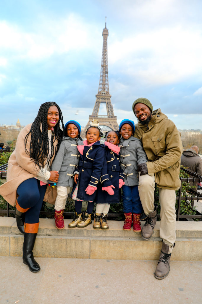 Black family with kids in front of Eiffel Tower