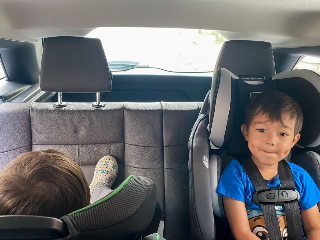 Packed back seat with two toddler convertible car seats