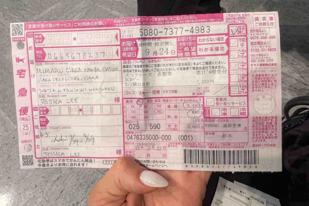 Close-up of a completed Yamato delivery slip, mostly all in Japanese, but some English, showing receiver details and a breakdown of fees for a shipment to Osaka. 