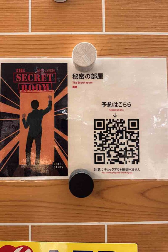 Poster and QR code sign for “The Secret Room” game at a Mimaru Osaka hotel, introducing an interactive experience for families.