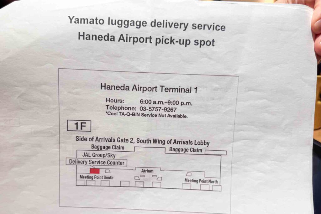 A printed handout highlights the Yamato luggage delivery pickup spot at Haneda Airport Terminal 1, with contact details and a map. 