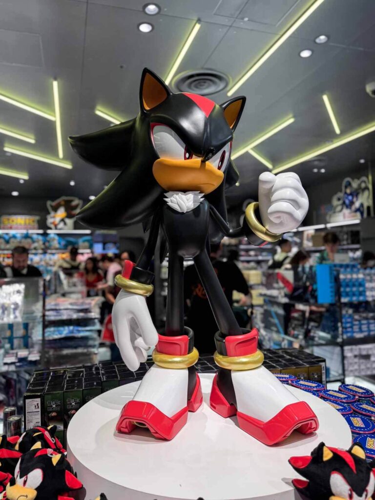 A large Shadow the Hedgehog from Sonic statue stands on display inside a SEGA store inside Shibuya Parco in Tokyo, surrounded by other Sonic plush toys and merchandise.