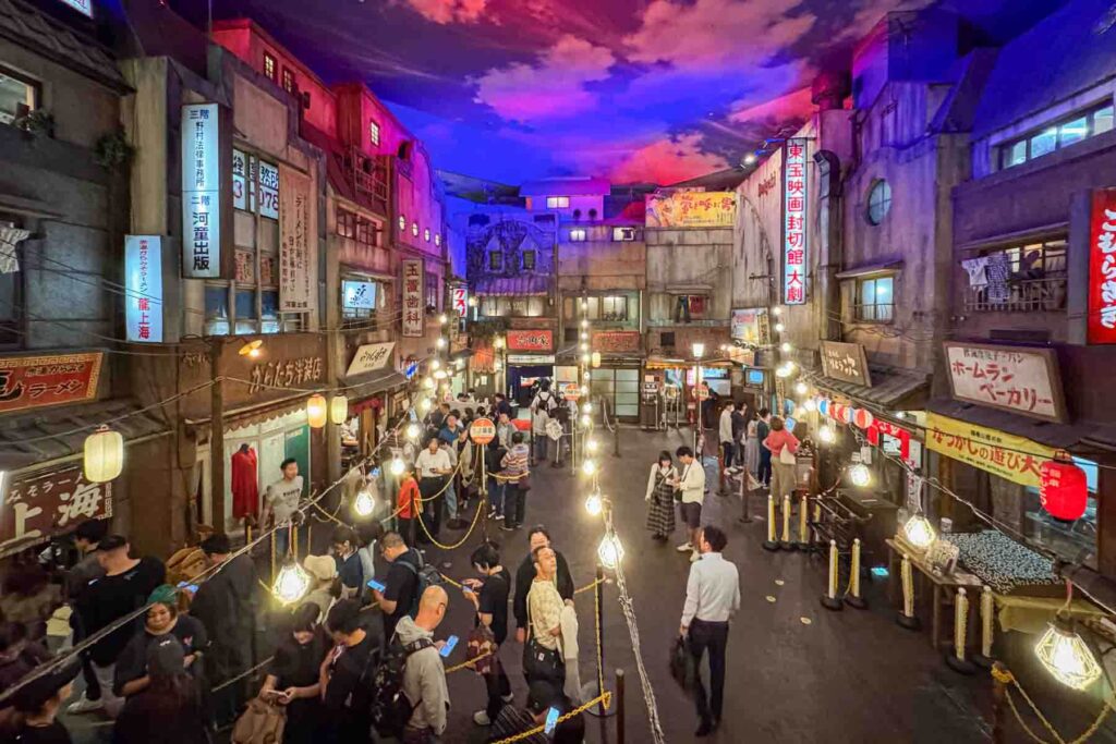 Indoor street scene inside the Shin Yokohama Ramen Museum designed like a retro Japanese neighborhood with lanterns signs and small stalls. This food theme park is a memorable family friendly stop in Japan.