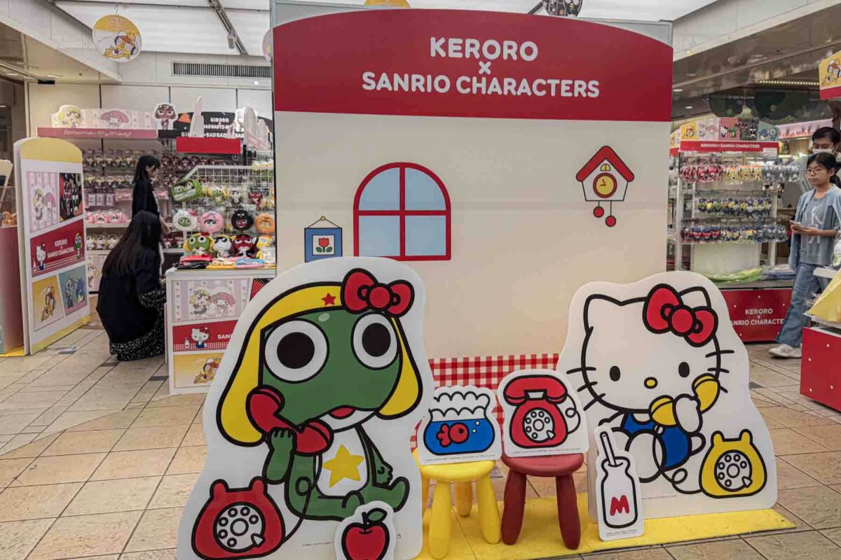 Character display at Tokyo Station Character Street featuring "KERORO × SANRIO CHARACTERS" with Hello Kitty and Keroro decorations inside a themed shopping area. Tokyo character stores are fun indoor attractions and shopping for kids and anime fans exploring the city.